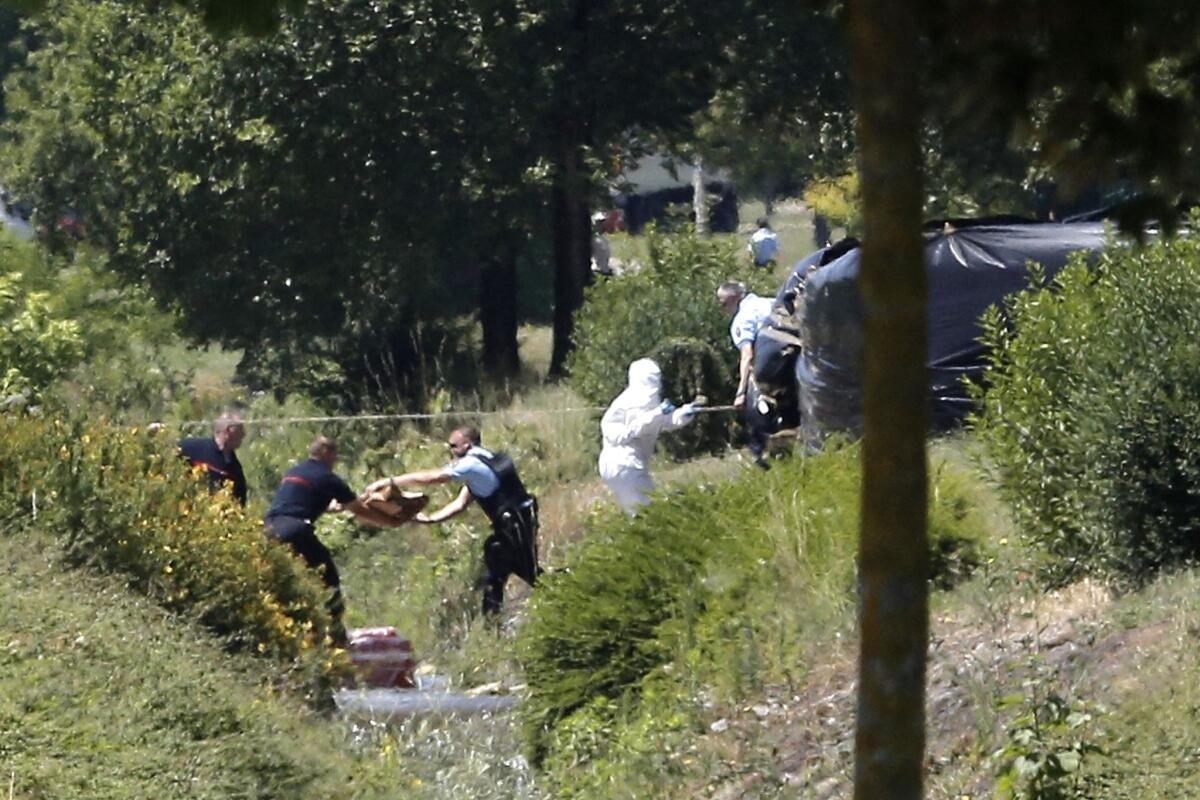 Police investigate outside the plant where an attack took place in Saint-Quentin-Fallavier, France.