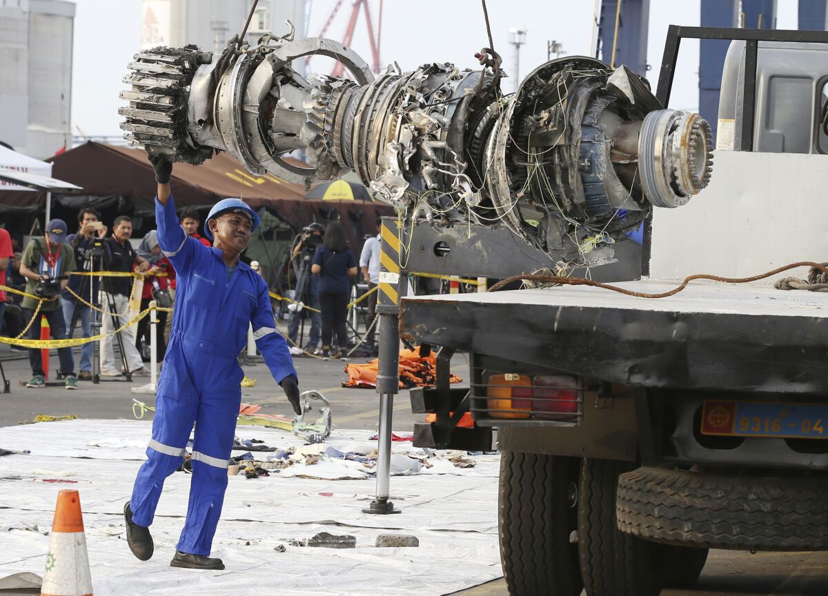 An official moves a recovered engine from the crashed Lion Air jet for further investigation in Jakarta, Indonesia.