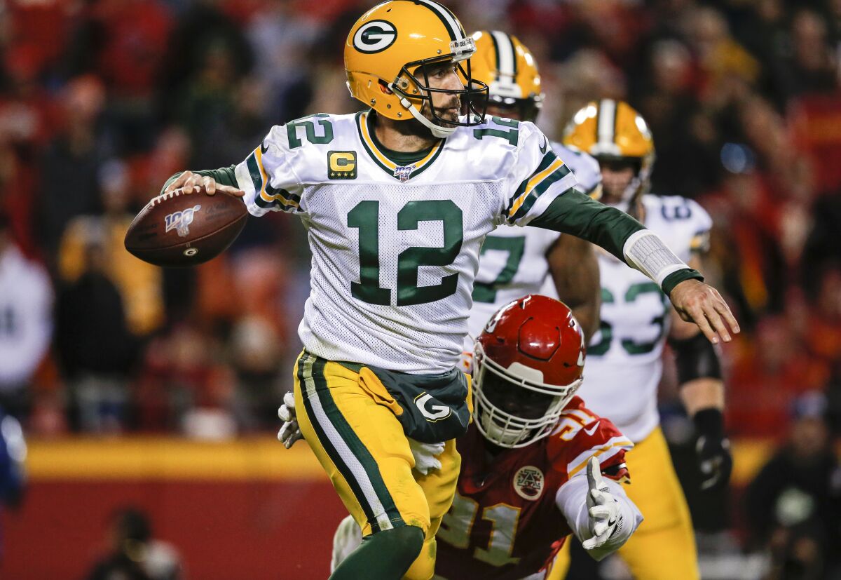 Packers quarterback Aaron Rodgers eludes Chiefs defensive end Derrick Nnadi during the third quarter of Green Bay's win Sunday.