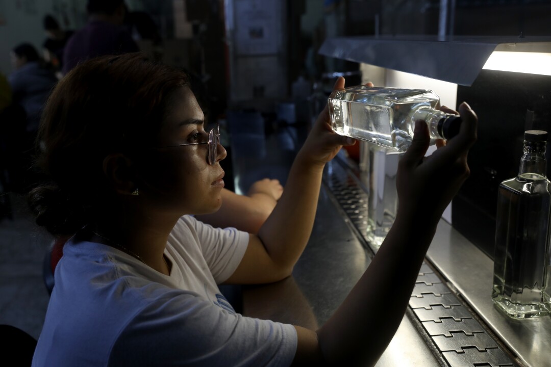 Monsarat Delgado checks tequila bottles for impurities
