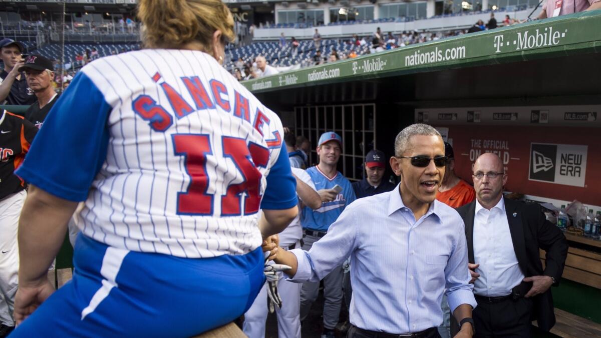 President Obama shakes hands with Rep. Linda Sanchez as Rep. Eric Swalwell looks on during the 2015 Congressional Baseball Game. (Bill Clark / CQ Roll Call)