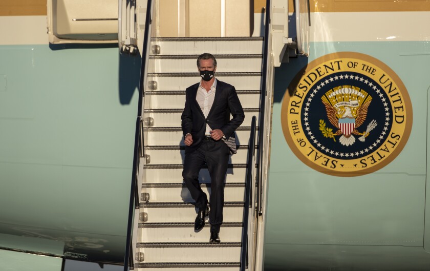 Gov. Gavin Newsom disembarks Air Force One in Long Beach during President Biden's visit to California on Sept. 13, 2021. 