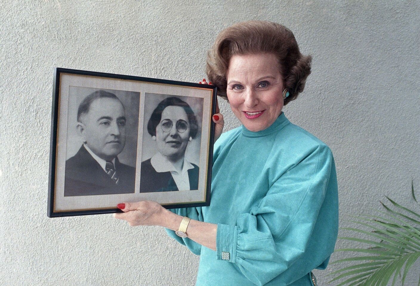 Pauline Friedman Phillips -- also known as Abigail Van Buren, the first writer of the "Dear Abby" column -- holds a photograph showing her mother and father.