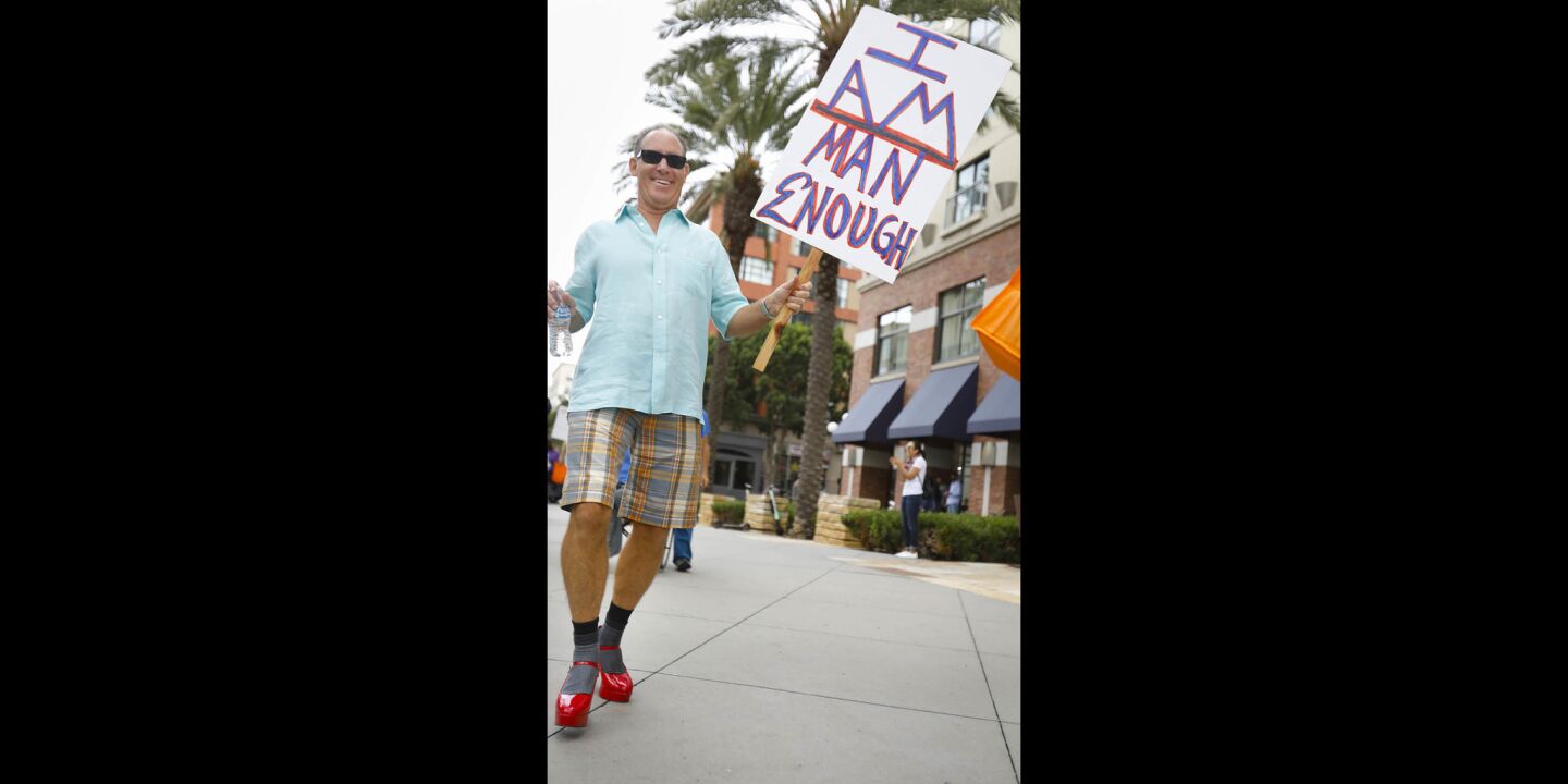 Jim Schabarum of Point Loma Park, sporting red high heels was one of a couple of hundred people to walk through the Gaslamp Quarter during the YWCA'S 11th annual "Walk a Mile in Her Shoes," taking a stand against domestic violence.
