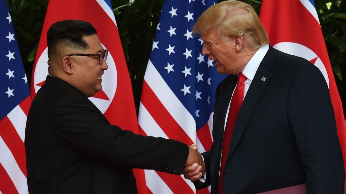 Korea's leader Kim Jong Un shakes hands with U.S. President Donald Trump at the end of the summit.