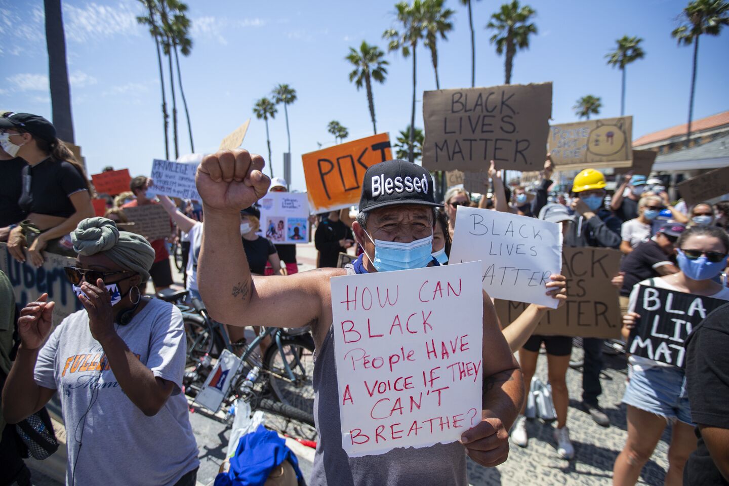 Demonstrators protesting George Floyd's death and supporting the Black Lives Matter movement participate in a peaceful demonstration near the Newport Beach Pier on Wednesday.