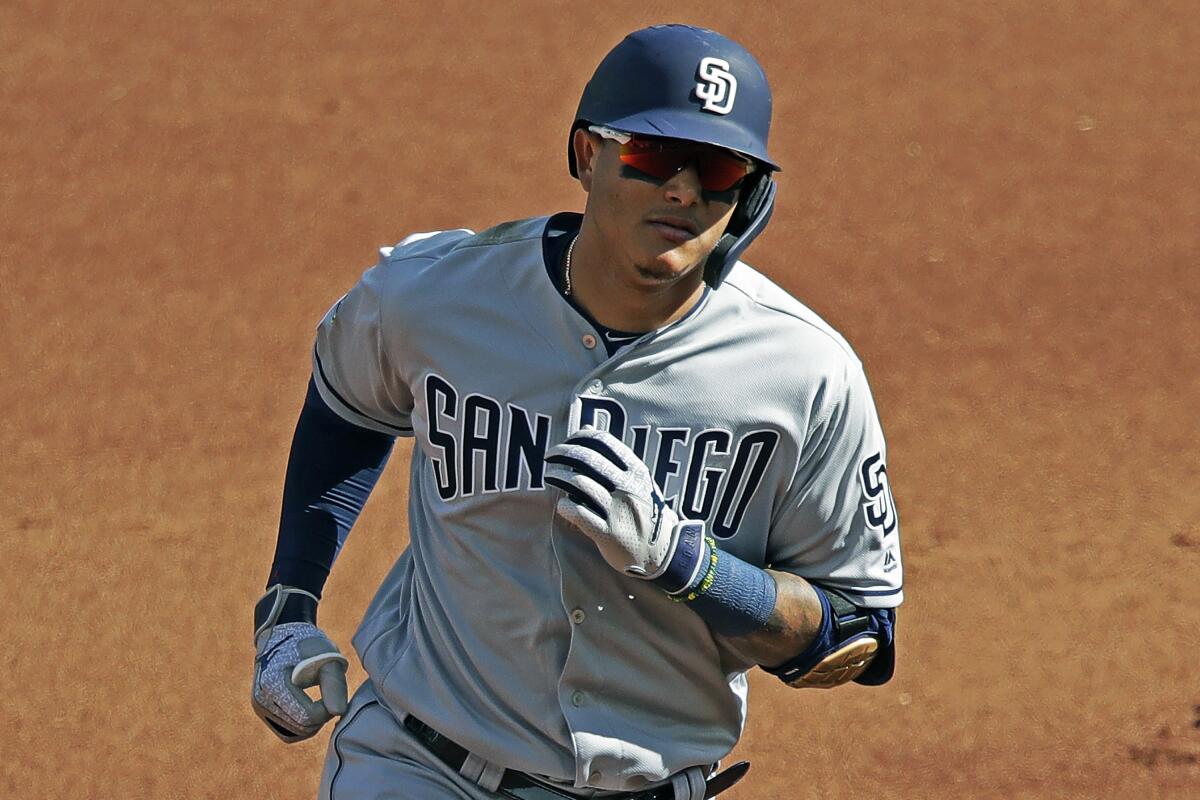 Manny Machado of the San Diego Padres rounds the bases after