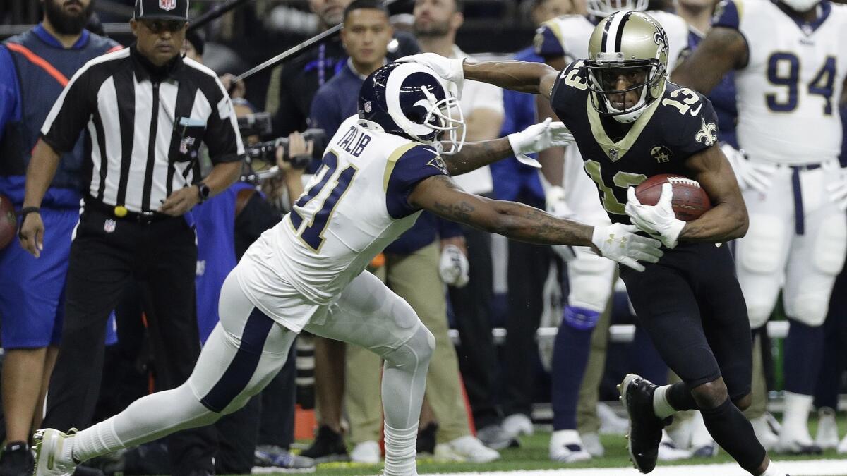 New Orleans Saints' Michael Thomas tries to get away from Los Angeles Rams' Aqib Talib during the first quarter.