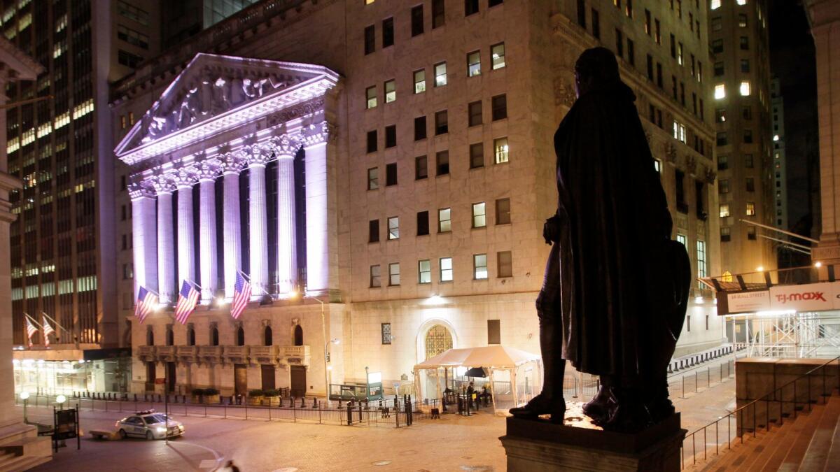 A statue of George Washington stands near the New York Stock Exchange.