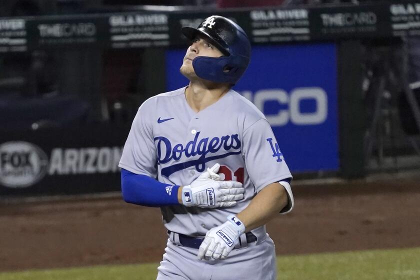 Los Angeles Dodgers' Kiké Hernandez touches the jersey No. 21.