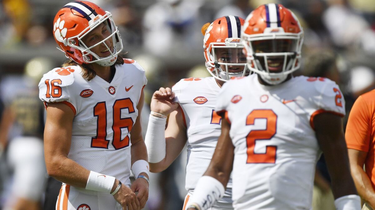 Clemson quarterbacks Trevor Lawrence (16) and Kelly Bryant (2) warm up before a game. Bryant is leaving the No. 4-ranked Tigers after Lawrence was selected the starter.