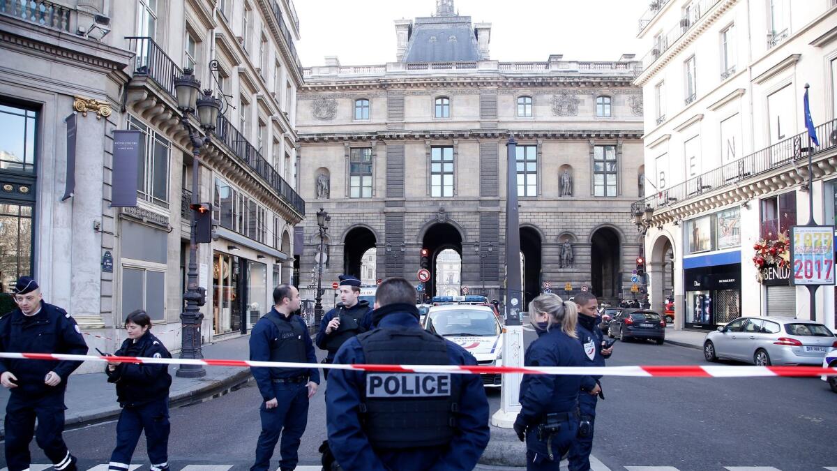Police cordon off the area near the Louvre in Paris on Friday after a French soldier shot a man in a shopping mall beneath the museum.