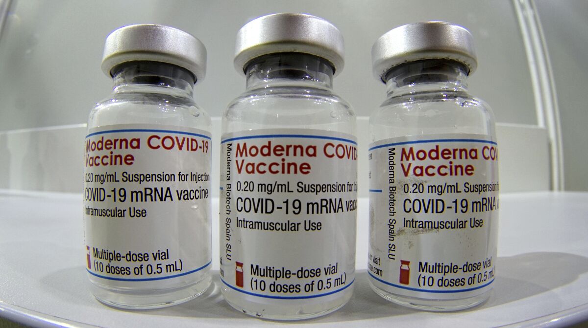 Three vials of the Moderna COVID-19 vaccine are pictured.