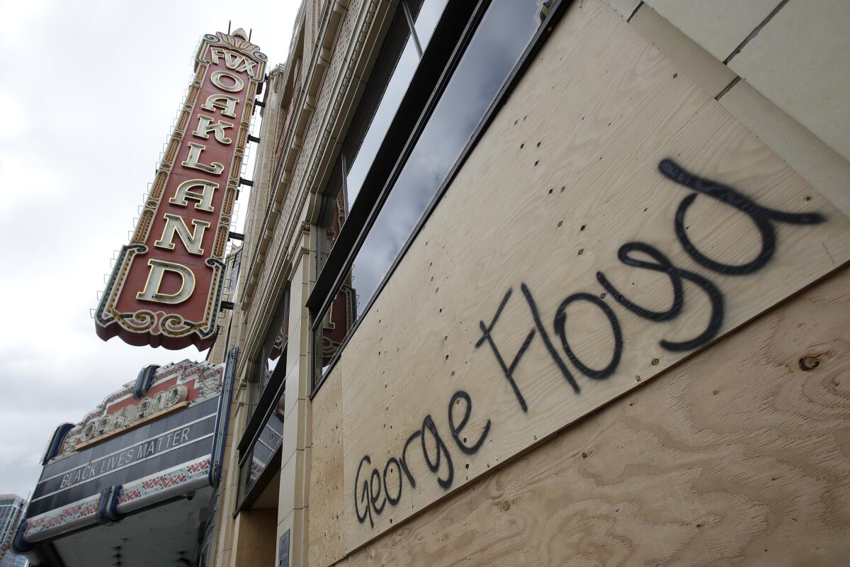 George Floyd's name is written on a boarded-up window at Oakland's Fox Theater on May 30.