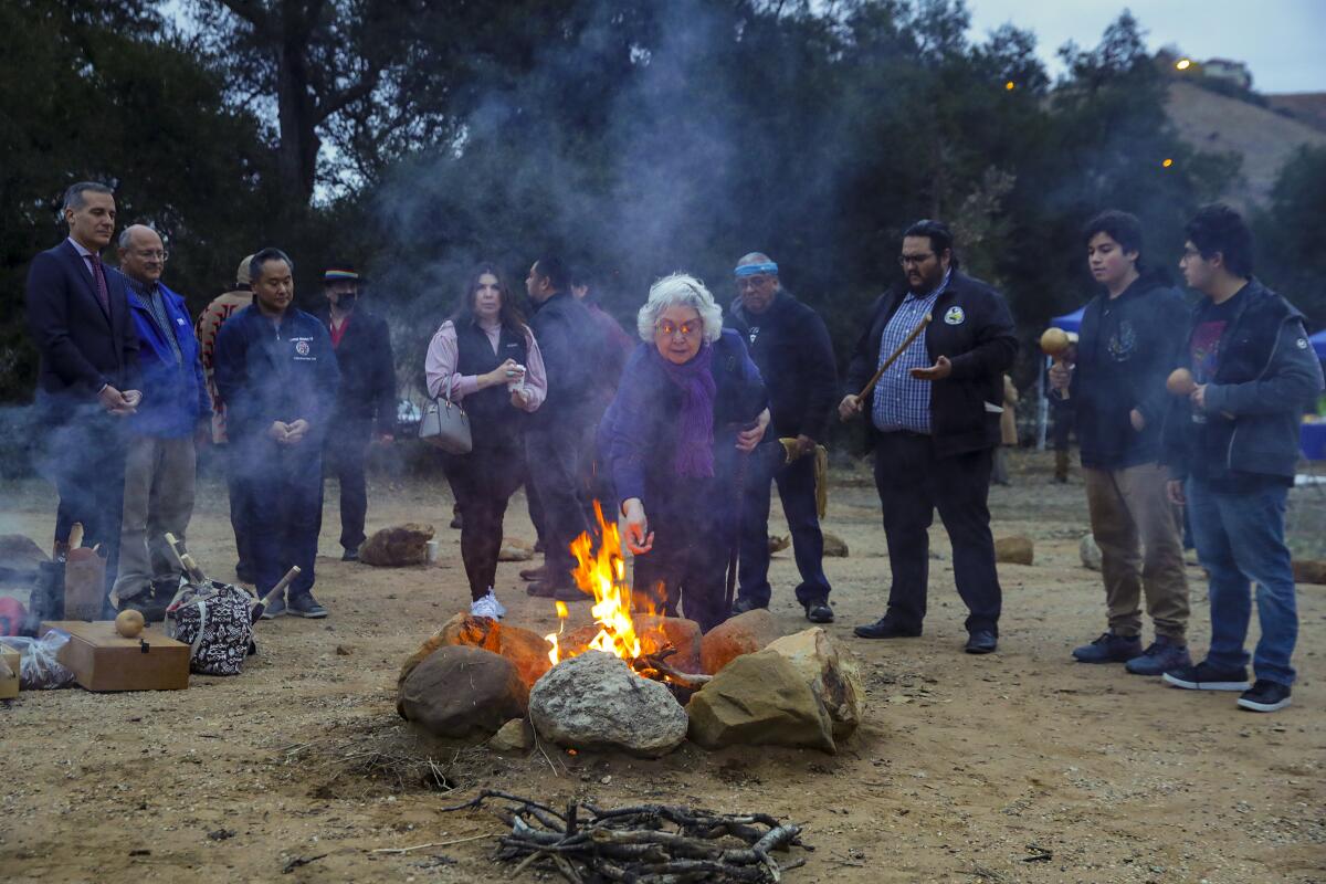 Bernice Cooke, a Fernandeño Tataviam tribal elder, makes a sacred tobacco offering at Chatsworth Nature Reserve.
