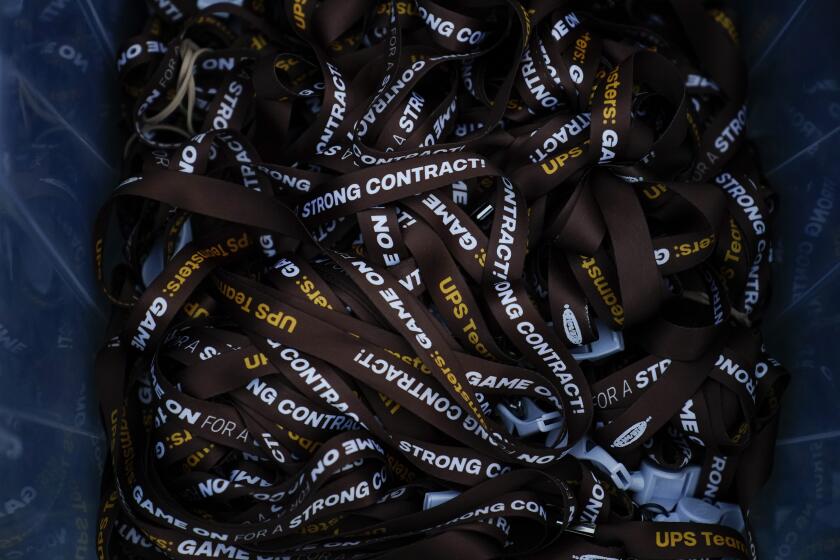 UPS lanyards are seen before a rally, Friday, July 21, 2023, in Atlanta, as a national strike deadline nears. The Teamsters said Friday that they will resume contract negotiations with UPS, marking an end to a stalemate that began two weeks ago when both sides walked away from talks while blaming each other. (AP Photo/Brynn Anderson)