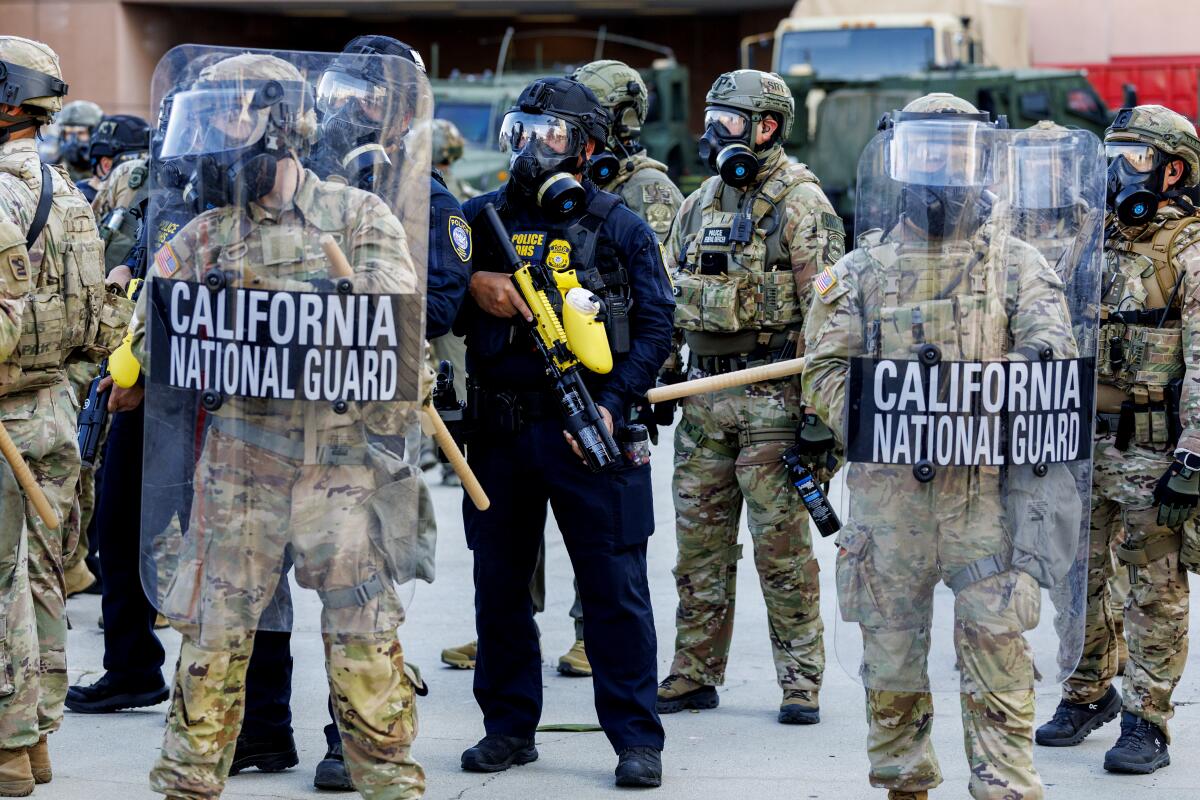 California National Guard troops stand along the back of the Federal Building during ICE protests June 12.