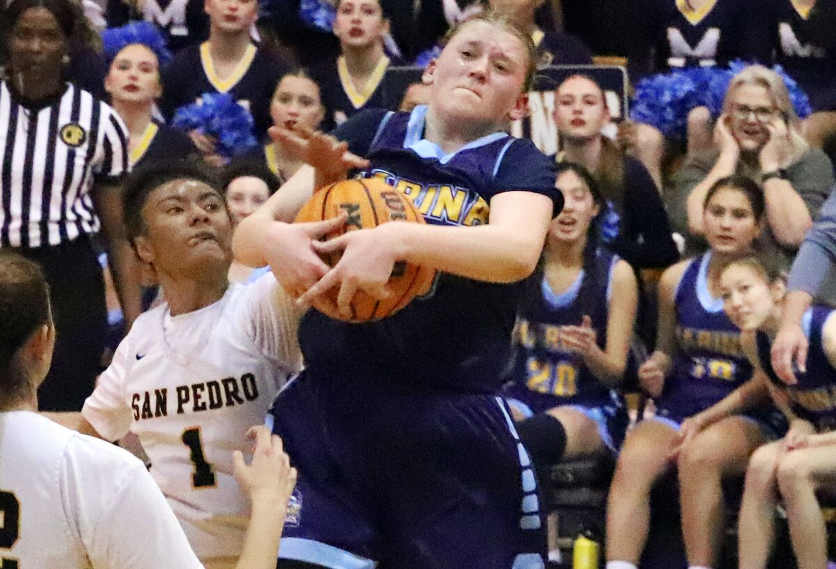 Marina's Sydnie Smith (25) grabs a rebound against San Pedro on Tuesday.