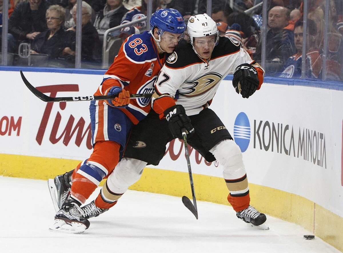 Ducks' Hampus Lindholm (47) and Oilers' Matthew Benning (83) vie for the puck during the first period on Dec. 3.