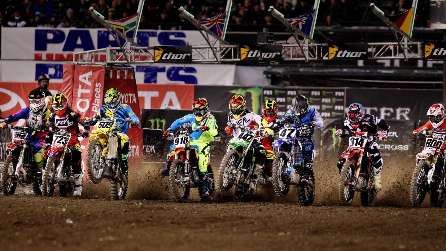 Riders in the 450SX heat 1 qualifying round power out of the starting gate during their race at Angel Stadium on Jan. 9.