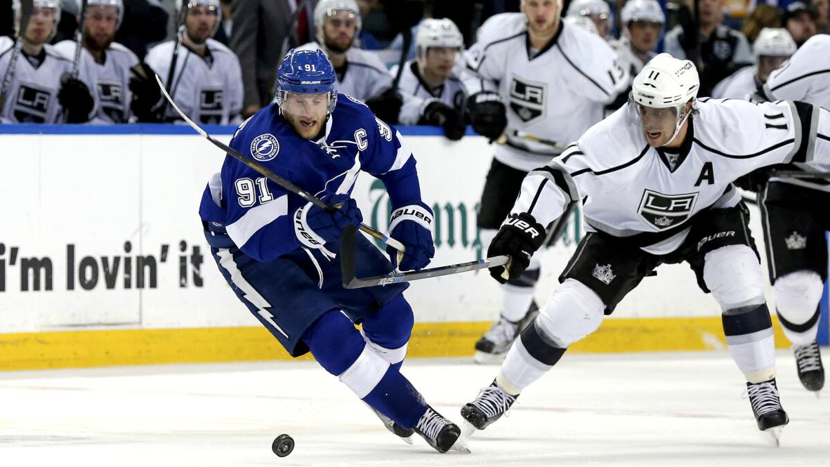 Kings center Anze Kopitar tries to prevent Lightning center Steven Stamkos (91) from breaking away with the puck in the second period Wednesday.
