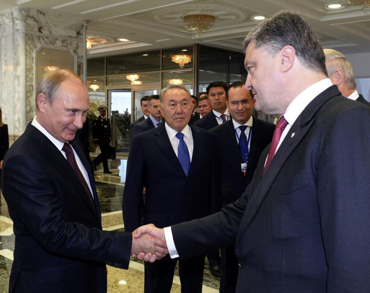 Russian President Vladimir Putin shakes hands with Ukrainian President Petro Poroshenko in Minsk, Belarus, on Aug. 26.