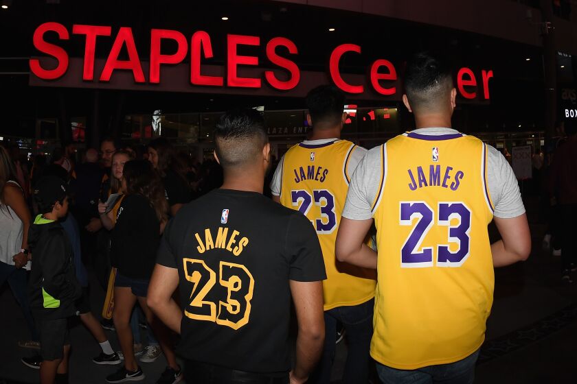 Fans wearing LeBron James jerseys head into Staples Center before the Lakers-Houston Rockets game on Oct. 20, 2018.