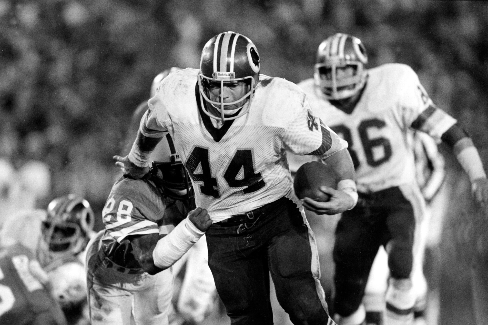 Washington running back John Riggins eludes a tackle attempt by Miami Dolphins' Don McNeal.