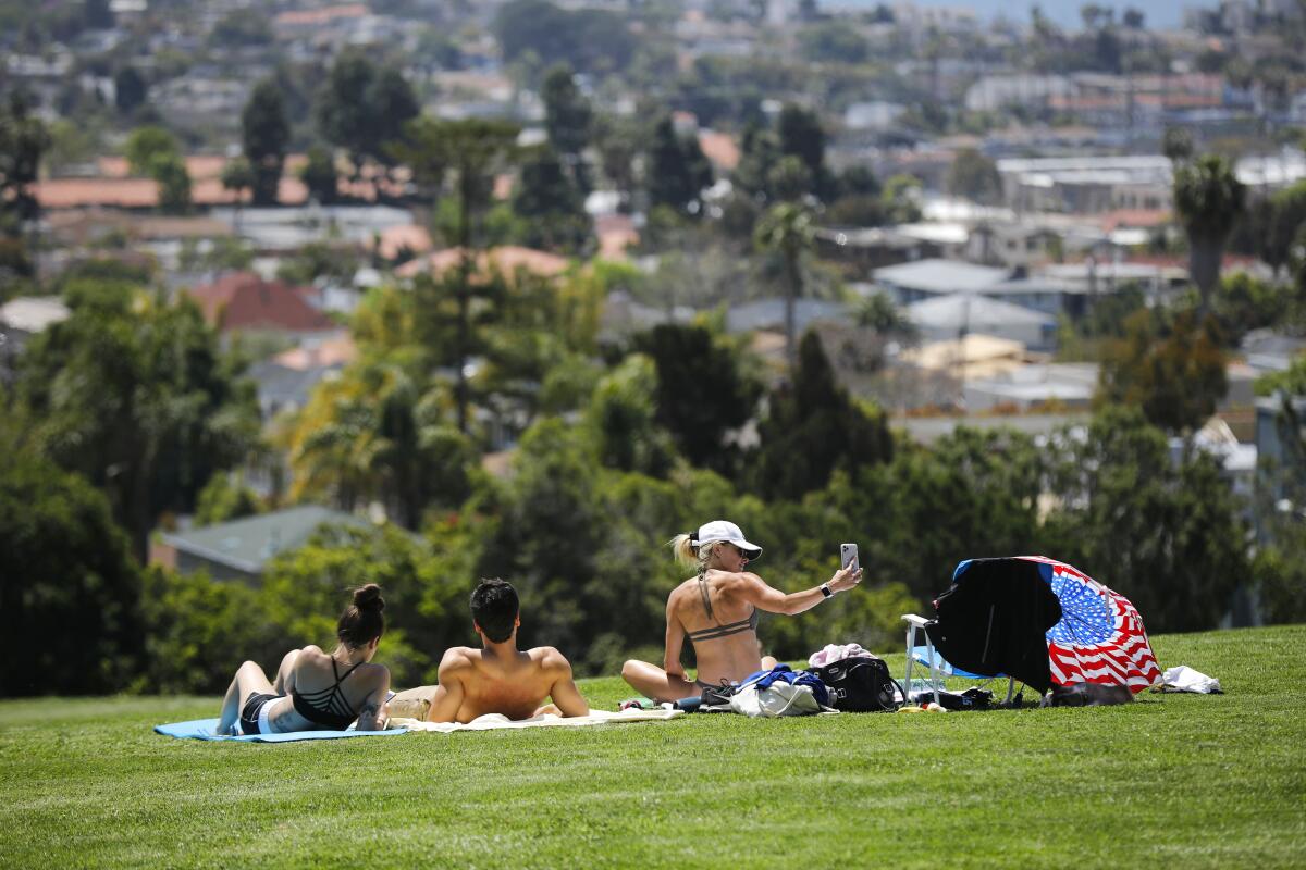 San Diegans lie in the sun at Kate Sessions Park in Pacific Beach in April 2020.