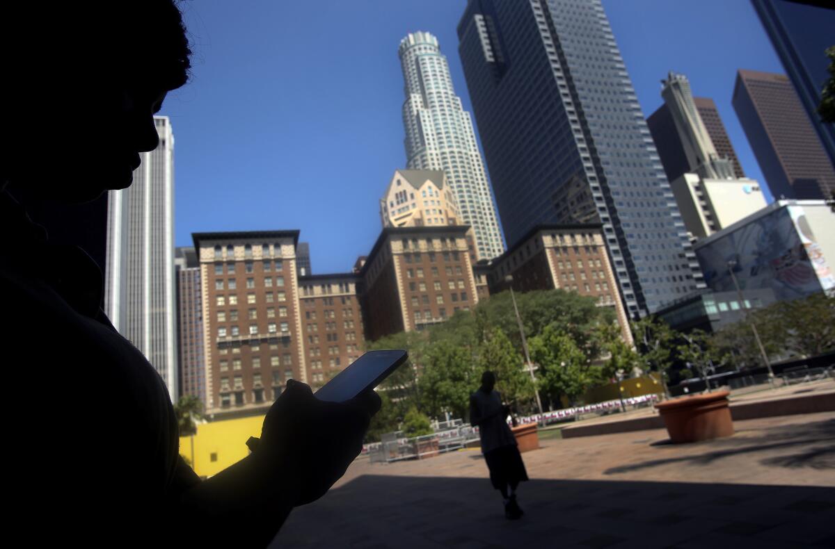 Shanese Diamond connects to the Internet using free Wi-Fi at Pershing Square in downtown Los Angeles. Newer GPS devices can help you find nearby locations offering free Wi-Fi.