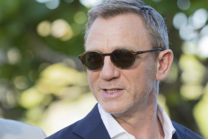 FILE - In this Thursday, Apriil 25, 2019 file photo, actor Daniel Craig poses for photographers during the photo call of the latest installment of the James Bond film franchise, in Oracabessa, Jamaica. Producers of the forthcoming James Bond thriller say the film's release has been delayed again, until the fall of 2021, because of the effects of the coronavirus pandemic. The official 007 Twitter account said late Thursday, Jan. 21, 2021 that the 25th installment in the franchise will now open on Oct. 8. (AP Photo/Leo Hudson, File)