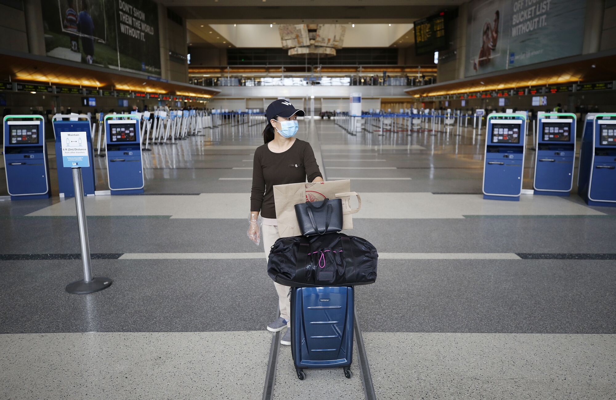 A woman in a face mask at Tom Bradley International Terminal at LAX in early May.