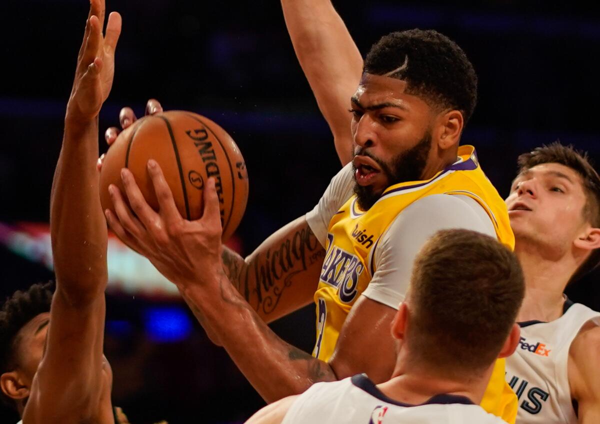 Lakers star Anthony Davis grabs one of his 20 rebounds against the Memphis Grizzlies.