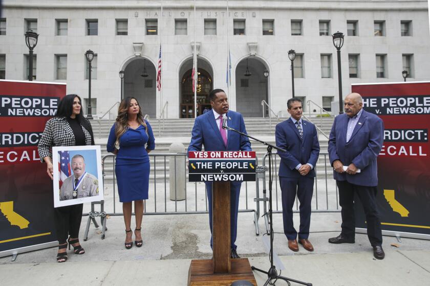 Los Angeles, CA - September 02: Republican gubernatorial candidate Larry Elder, center, addresses a news conference held to recall Los Angeles District Attorney George Gascon and Governor Gavin Newsom, in front of Hall of Justice on Thursday, Sept. 2, 2021 in Los Angeles, CA. (Irfan Khan / Los Angeles Times)