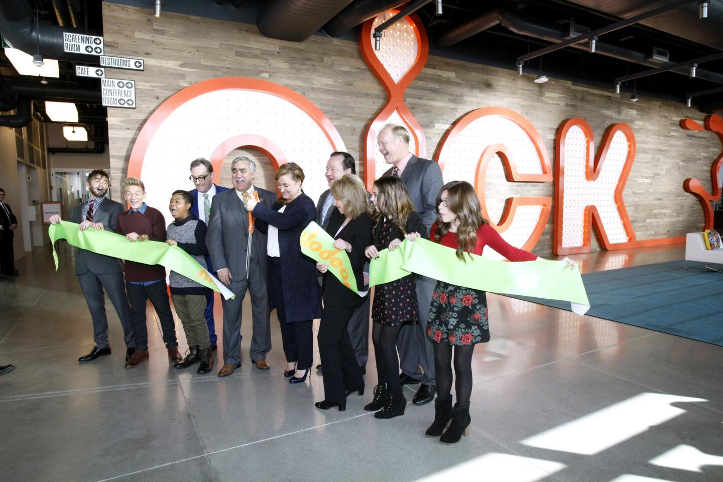 With Burbank mayor Jess Talamantes at center left, President of the Nickelodeon Group Cyma Zarghami, center right holding scissors, cut the ribbon during ceremony for their new state-of-the-art building at the Olive Avenue campus in Burbank on Wednesday, Jan. 11, 2017. The 5-story building, with more than 200,000 square-feet of space, will house more than 700 employees and more than 20 show productions.