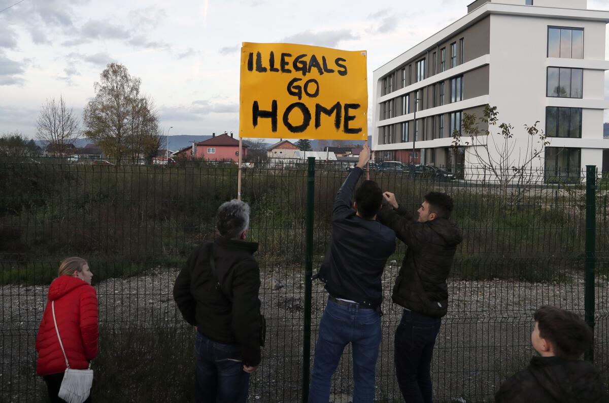 Protesters stand outside the Bira refugee camp in Bihac. Many Bosnians have expressed sympathy with migrants in view of their own war experience, but many also object to their presence.