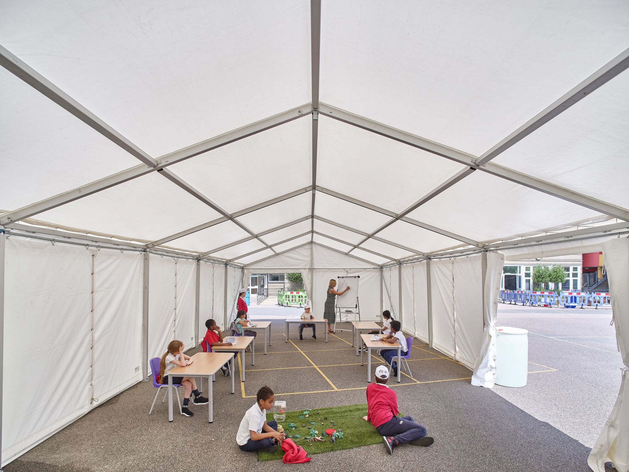 Students inside one of Curl la Tourelle Head Architecture's early tent projects at Manorfield Primary School in London.