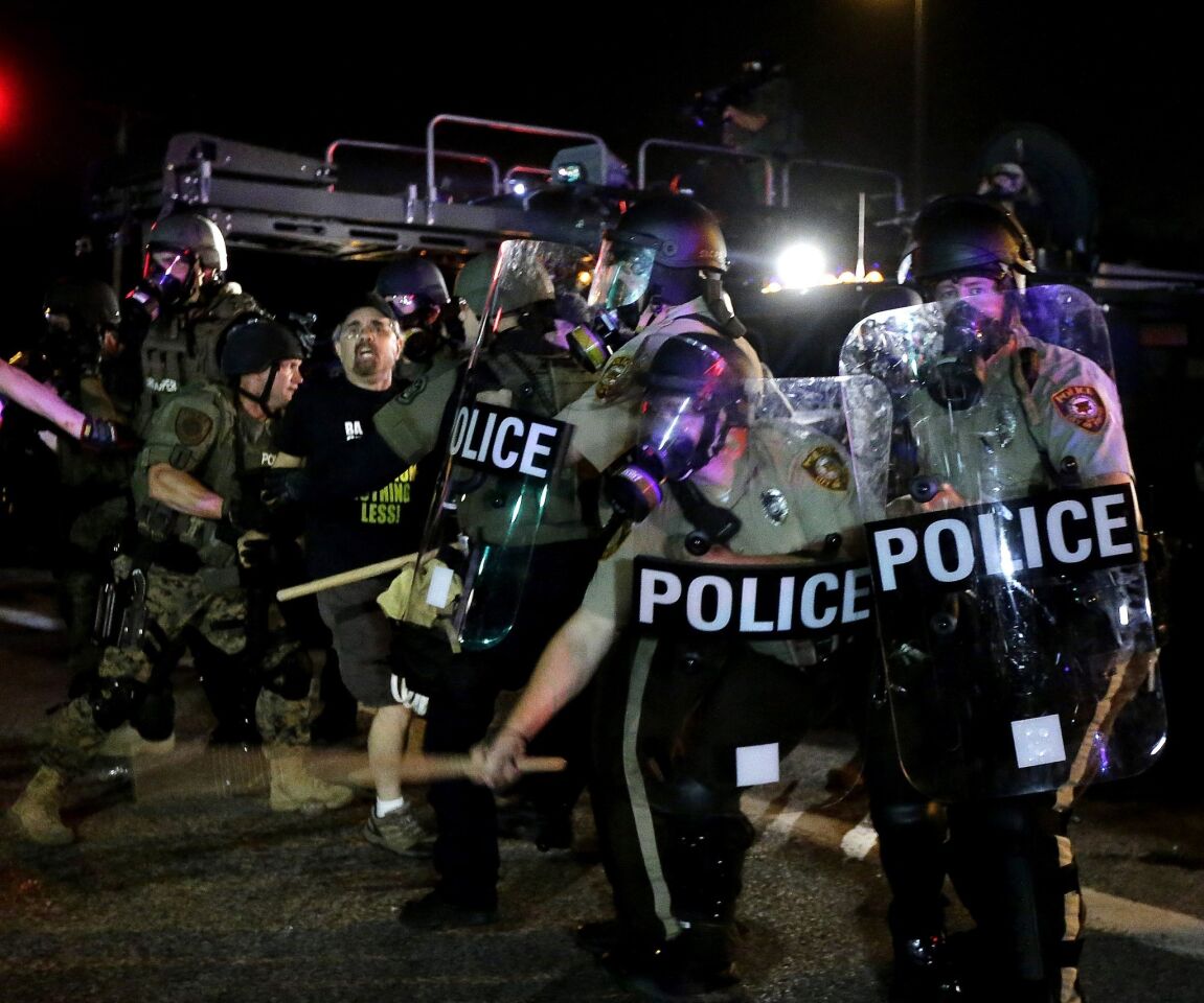 A man is detained after a standoff with police Monday during a protest for Michael Brown, who was killed by a police officer Aug. 9 in Ferguson, Mo.
