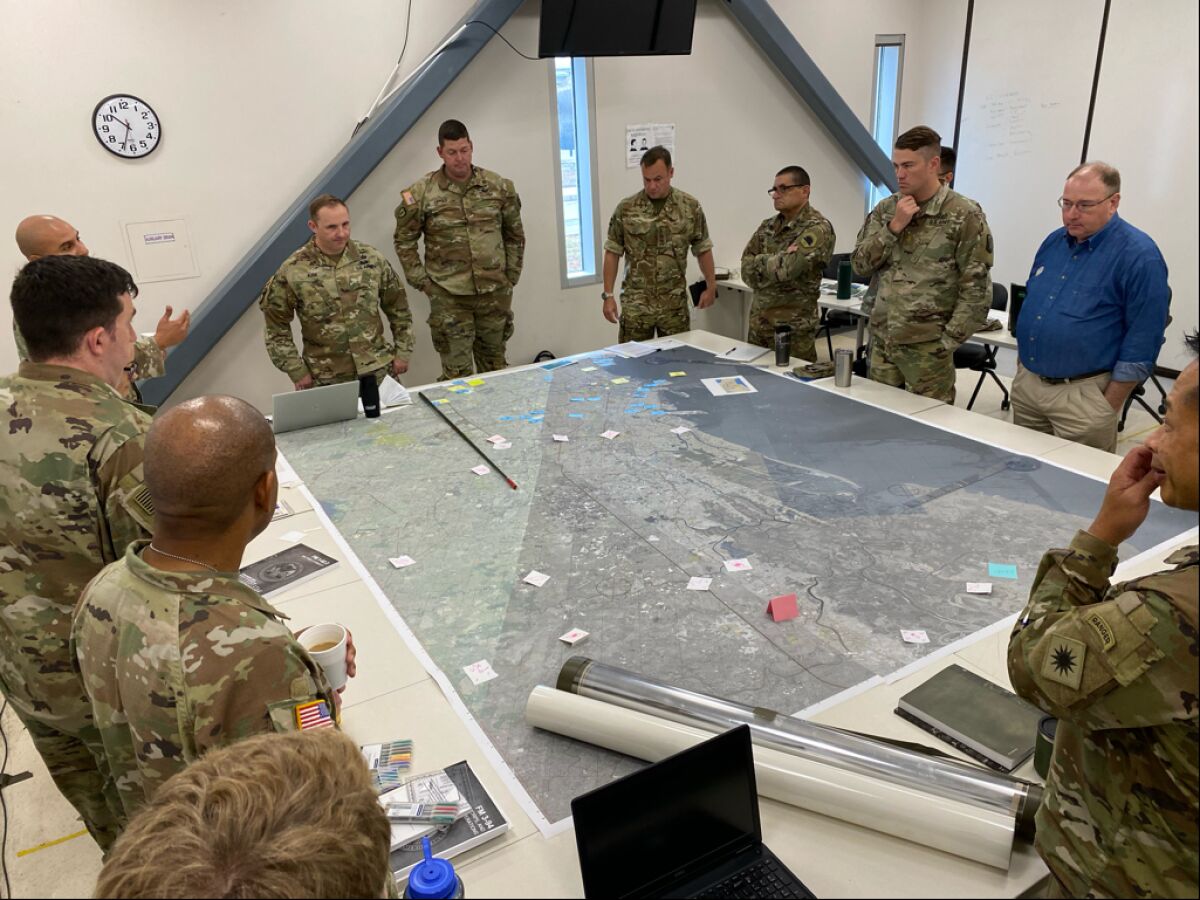 Soldiers survey a map during the urban planner course at Joint Forces Training Base Los Alamitos.