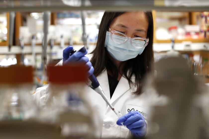 San Diego, CA - SEPT 30: Jenny Hu, Sr. Staff Scientist prepares proteins at Scripps Research on Thursday, Sept. 30, 2021 in San Diego, CA. Scripps Research scientists have teamed up with Moderna to develop and test an HIV vaccine that will use the same RNA technology that proved remarkably safe and effective against COVID-19. (K.C. Alfred / The San Diego Union-Tribune)