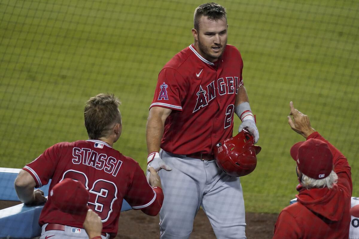 Angels' Mike Trout returns to the dugout after hitting a three-run home run against the Dodgers on Sept. 25.