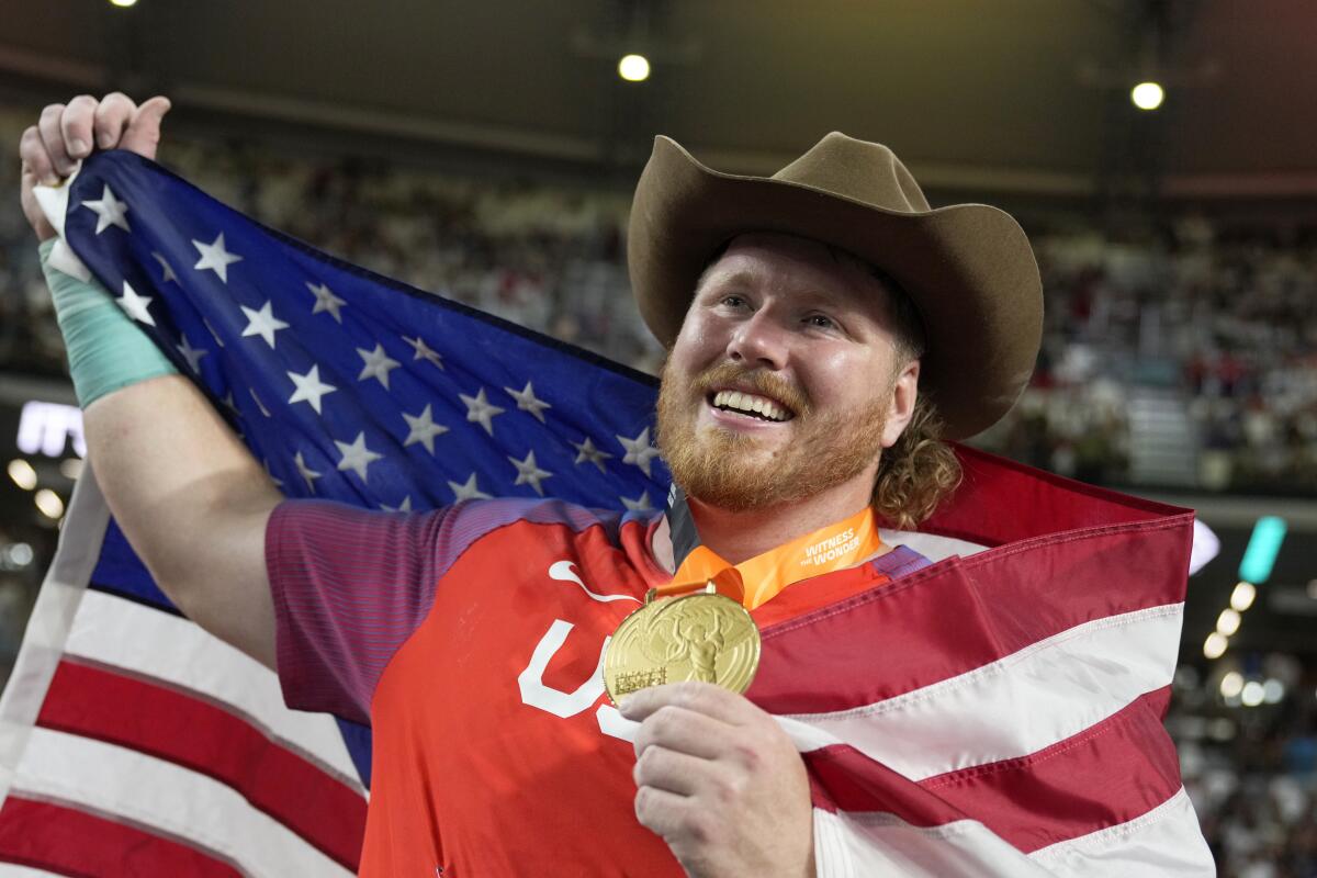 Ryan Crouser celebrates after setting a world record and winning gold in men's shotput at the World Athletics Championships.