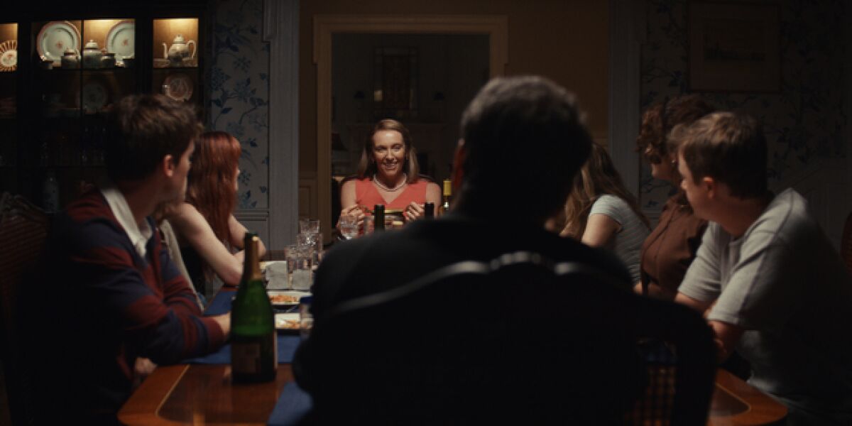 A woman at the dining room table with her family