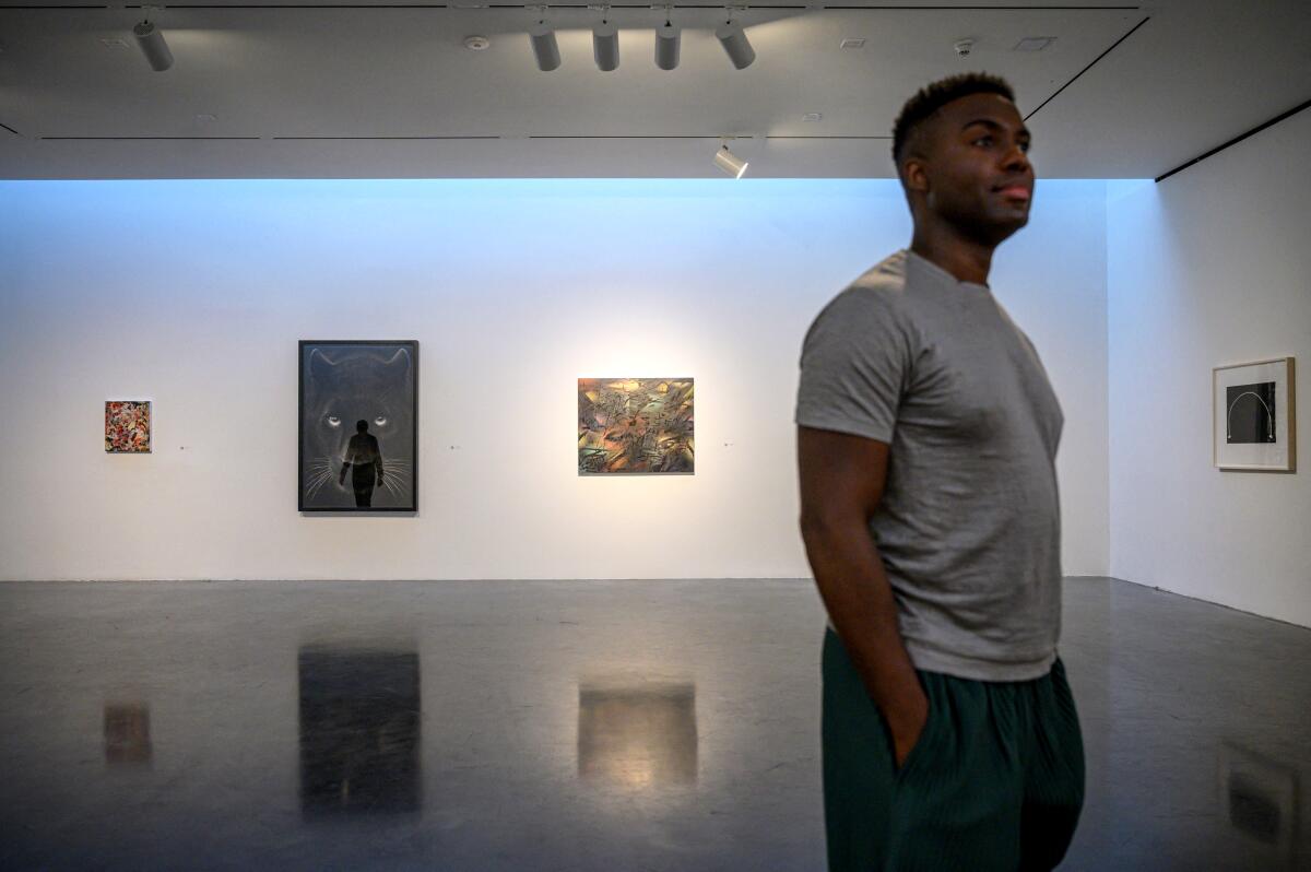 Conceptual artist Adam Pendleton stands amid an art exhibition that he co-curated