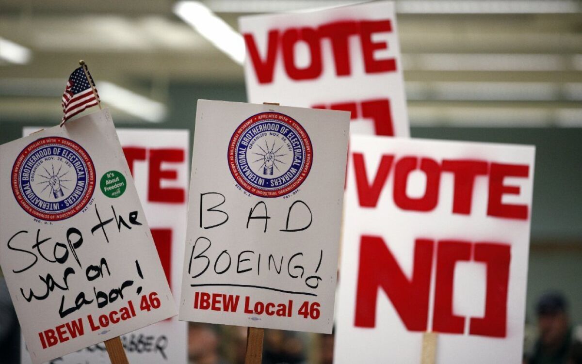 Signs at a rally prior to Friday's Boeing contract vote; the contract passed.