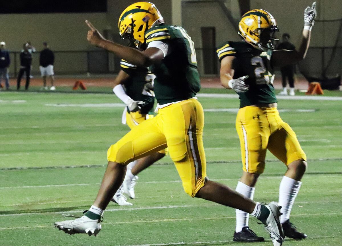 Edison quarterback Savelio Niumata (11) celebrates after scoring a touchdown against Palos Verdes on Friday.