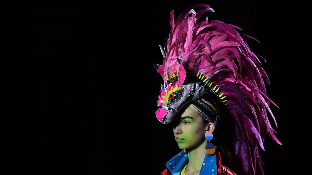 A model wears a head-mounted creation by Manish Arora during the designer's fall/winter 2019 fashion show in Paris.