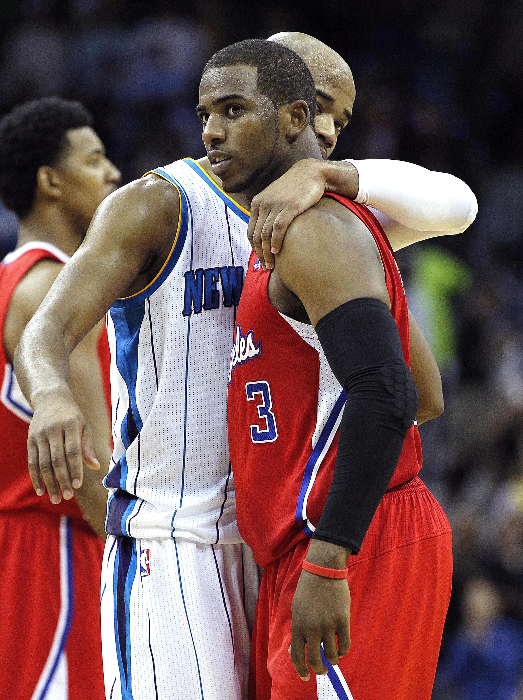 Hornets guard Jarrett Jack, left, hugs former teammate and Clippers guard Chris Paul.