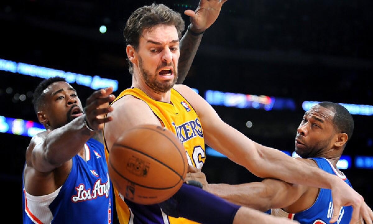 Lakers center Pau Gasol, middle, loses control of the ball while being double-teamed by Clippers center DeAndre Jordan, left, and guard Willie Green during the Lakers' blowout loss Thursday. Inconsistent performances in recent games makes it somewhat difficult to decipher what the Lakers are capable of accomplishing in their final 18 games.
