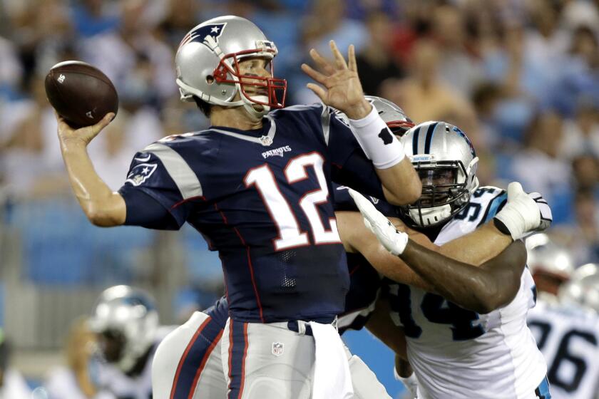 Patriots quarterback Tom Brady unleashes a pass against the Panthers on Friday night.